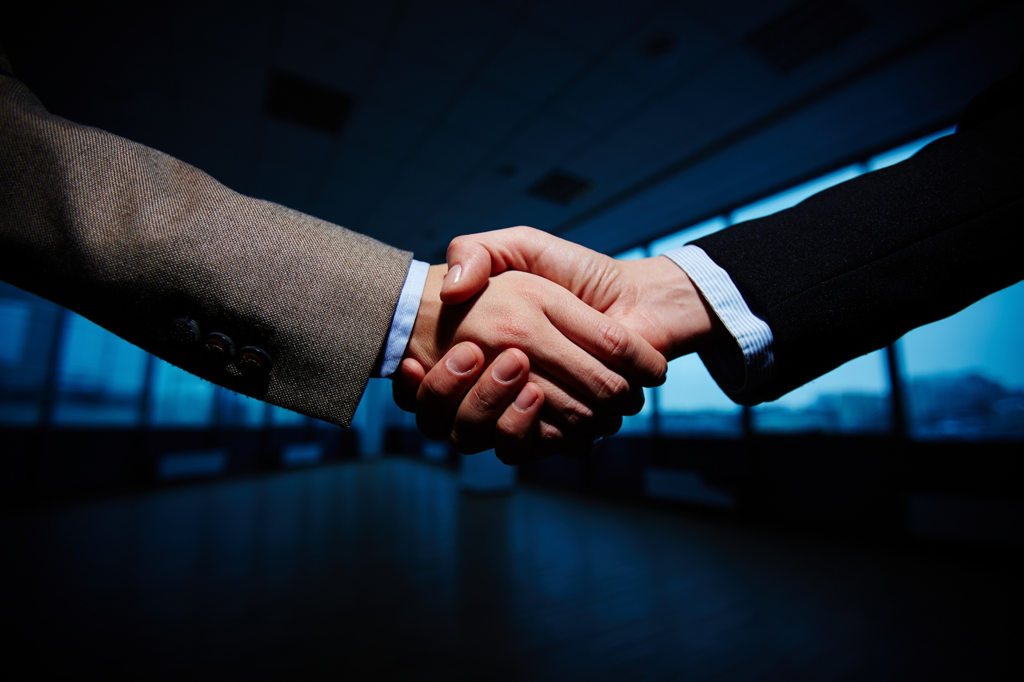 Professional handshake representing confidentiality, ethics, and operational order